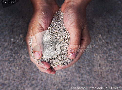 Image of Hands holding sand