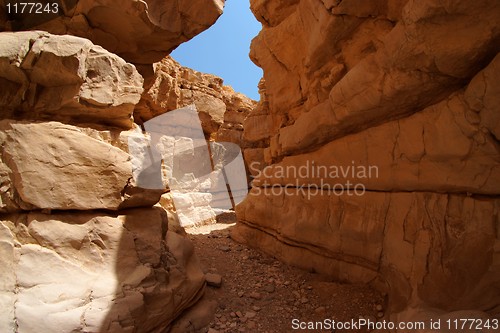 Image of Narrow slot between two rocks in desert canyon