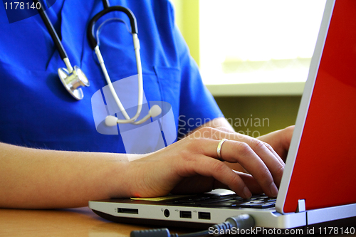 Image of Doctor sitting at  desk with laptop computer