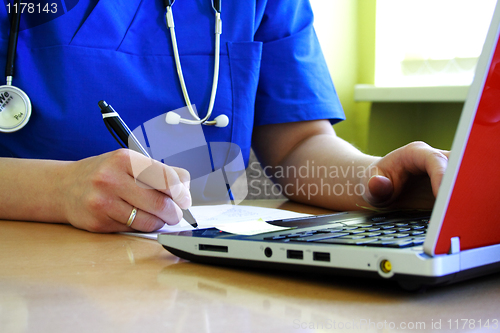 Image of Doctor sitting at desk with laptop computer