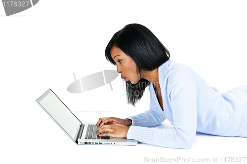 Image of Surprised woman using laptop computer