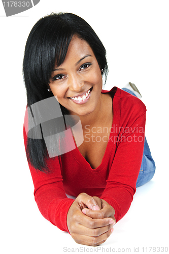 Image of Young woman smiling laying down