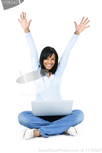 Image of Happy woman with computer rasing arms