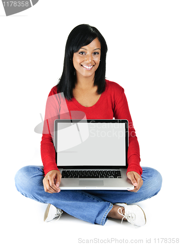 Image of Young woman holding laptop computer