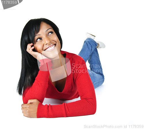 Image of Smiling young woman relaxing looking up