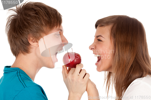 Image of boy and a girl biting the apple