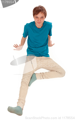 Image of Teen sits on the floor