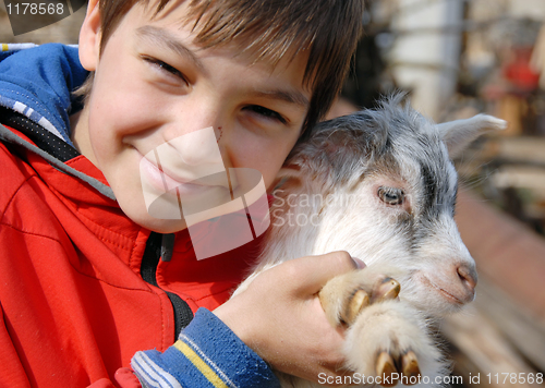 Image of Teenage boy with goatling