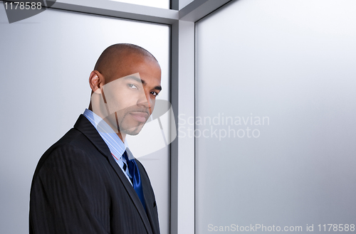 Image of Young businessman beside a window