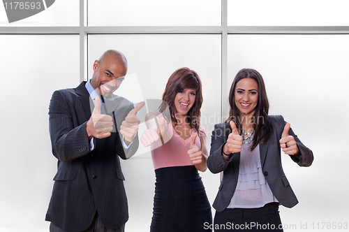 Image of Happy business team thumbs up