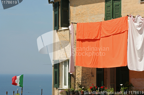 Image of Flag  and laundry hung on to dry, Corniglia.