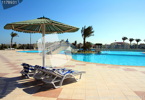 Image of parasol and swimming pool in hotel