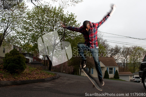 Image of Skateboarder Man Doing an Ollie Jump