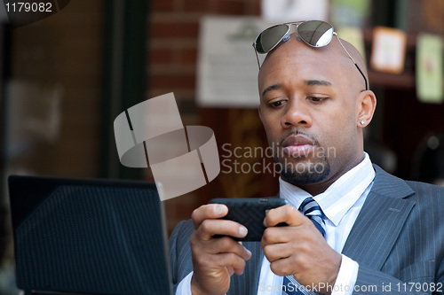 Image of Business Man Working Wirelessly and Mobile