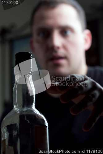 Image of Man Reaching For the Liquor Bottle