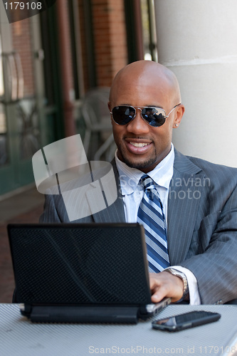 Image of Business Man Working Wirelessly and Mobile