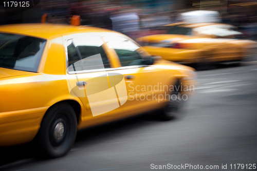 Image of Speeding Yellow Taxi Cabs Motion Blur