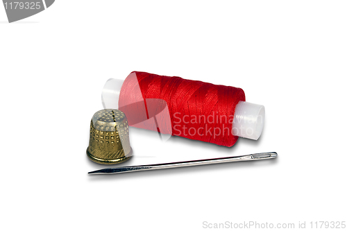 Image of Spool of thread. Needle. Thimble