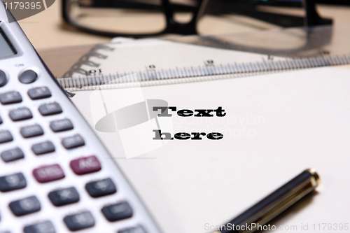 Image of pen ,book, ruler, calculator and glasses