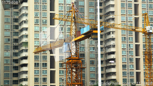 Image of Building of a skyscraper with two tower cranes 