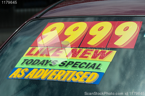 Image of price sticker on used car lot