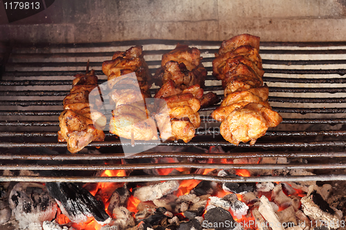 Image of four roasted tasty meat on garden grill
