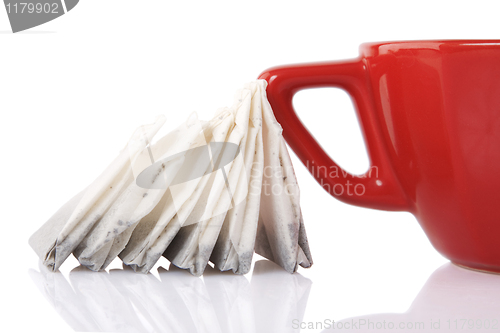 Image of Red Ceramic cup with tea bags 