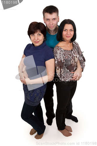 Image of man hugging two women