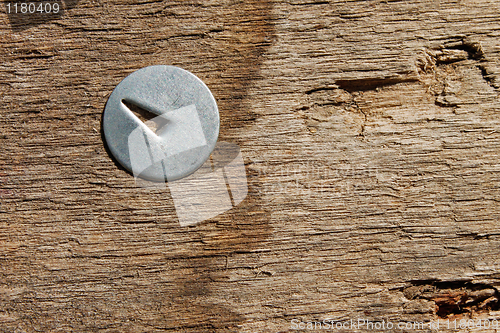 Image of Metal pin in wooden board