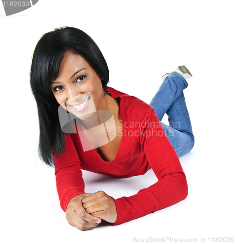 Image of Young woman smiling laying down