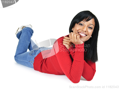 Image of Smiling young woman relaxing laying down