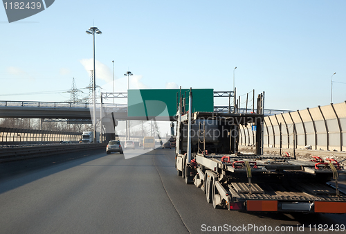 Image of truck with a trailer on the highway