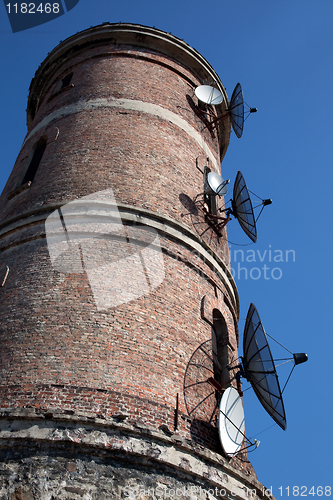 Image of Modern communications antenna on an old tower