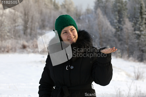 Image of A girl catches a snowflake