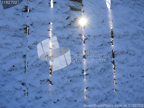 Image of fence under a snow and sun