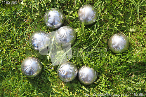 Image of petanque bowls in the green grass 