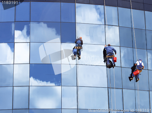 Image of Workers washing a skyscraper windows