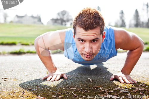 Image of Mixed race man doing push up