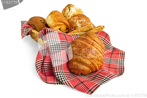Image of Croissant and muffins in a basket with a napkin