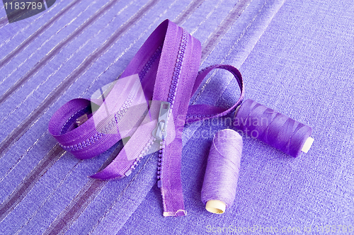 Image of Locking zipper and thread on the purple fabric