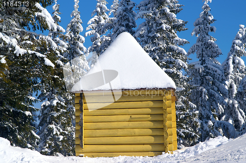 Image of Log cabin in snowy forest