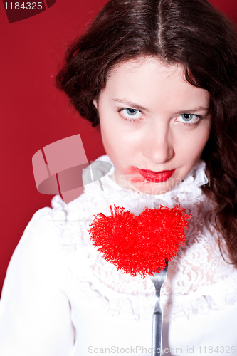 Image of woman with red heart on a fork