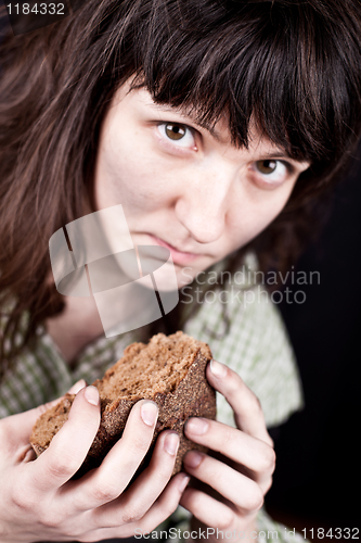 Image of beggar woman with a piece of bread