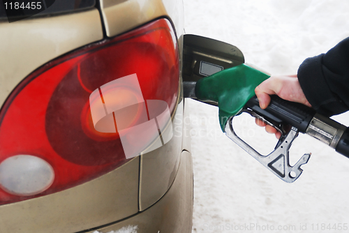 Image of close-up of a man's hand using a petrol pump