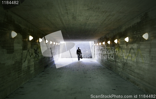 Image of man passing through underpass 