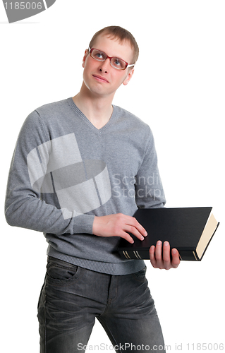 Image of Young student in glasses with a book in their hands