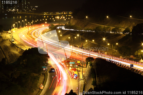 Image of road with car traffic at night and blurry lights showing speed a