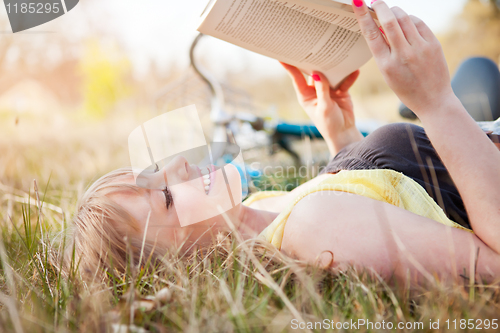 Image of Beautiful Caucasian woman reading outdoor