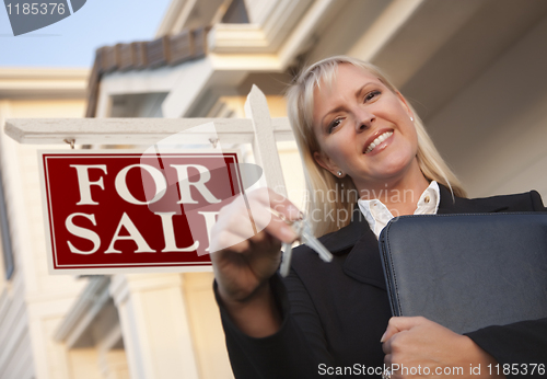 Image of Real Estate Agent with Keys in Front of Sign and House