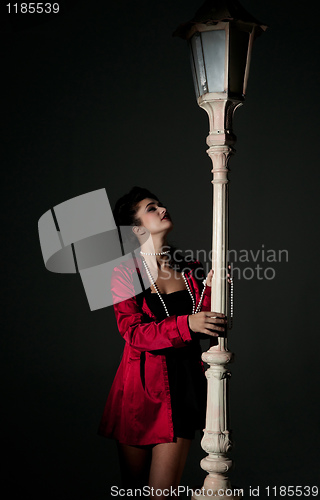 Image of young woman and lightpole